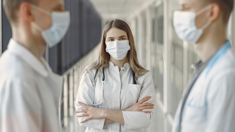 Woman in White Coat Wearing White Face Mask