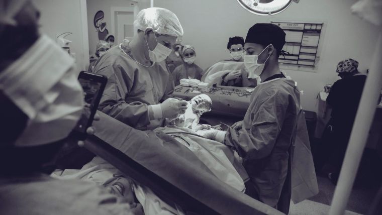 Doctor holding a baby after a c-section.